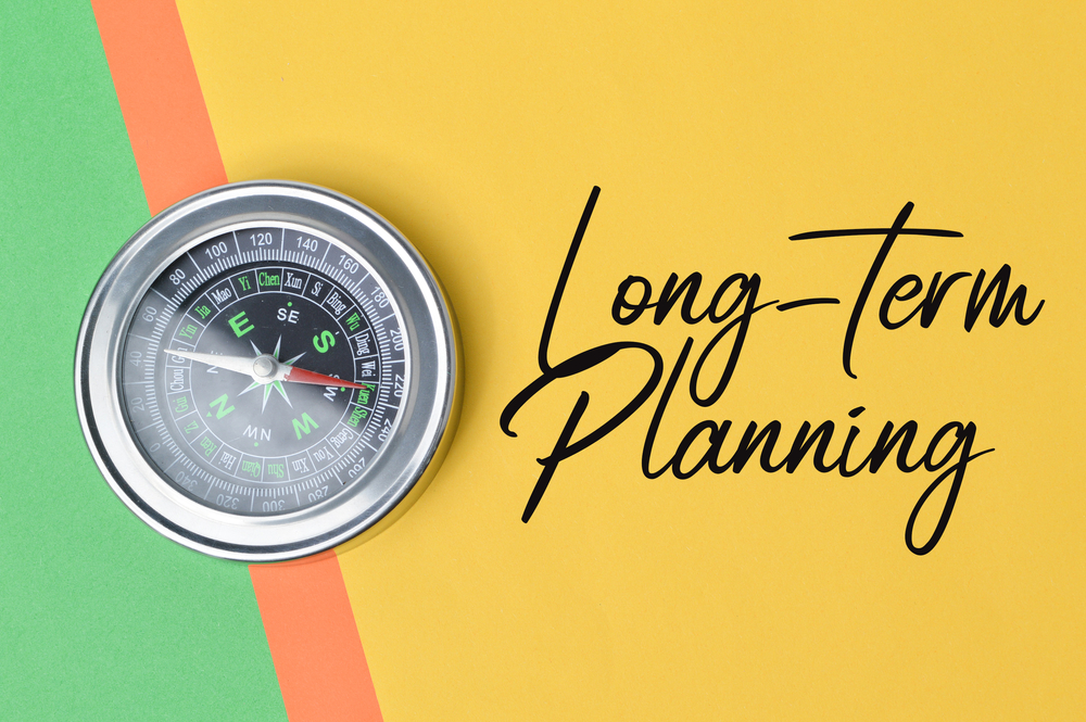 Top,View,Of,Compass,Over,Colorful,Paper,Written,With,Text